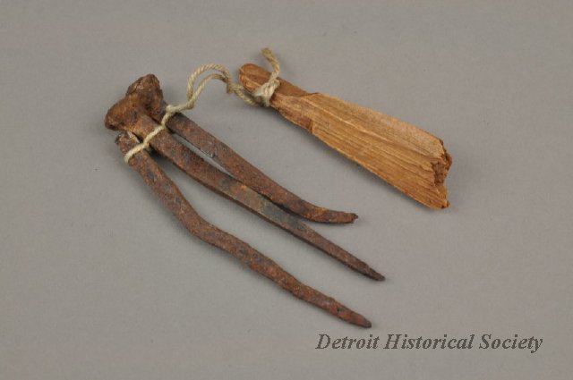 These three rustic-looking nails and this scrap of wood were donated along with the key. They were said to have been from Lewis Cass' home.